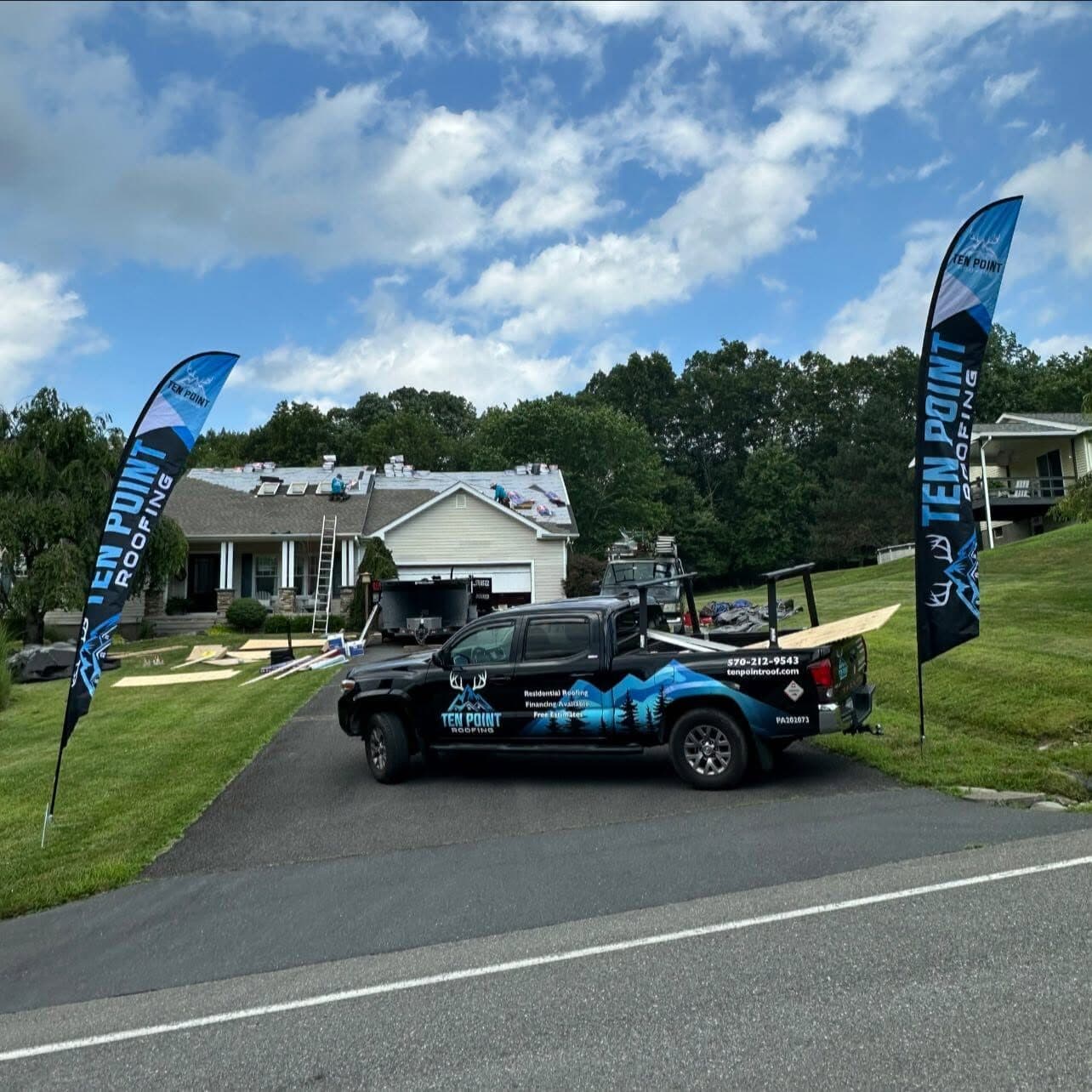 Ten Point Roofing branded truck with flags on a job site in Monroe County, PA